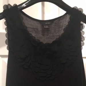 Black sleeveless top with petal detail at neckline